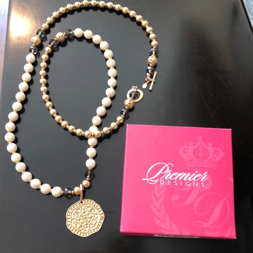 Long beaded costume gold necklace with pendant.